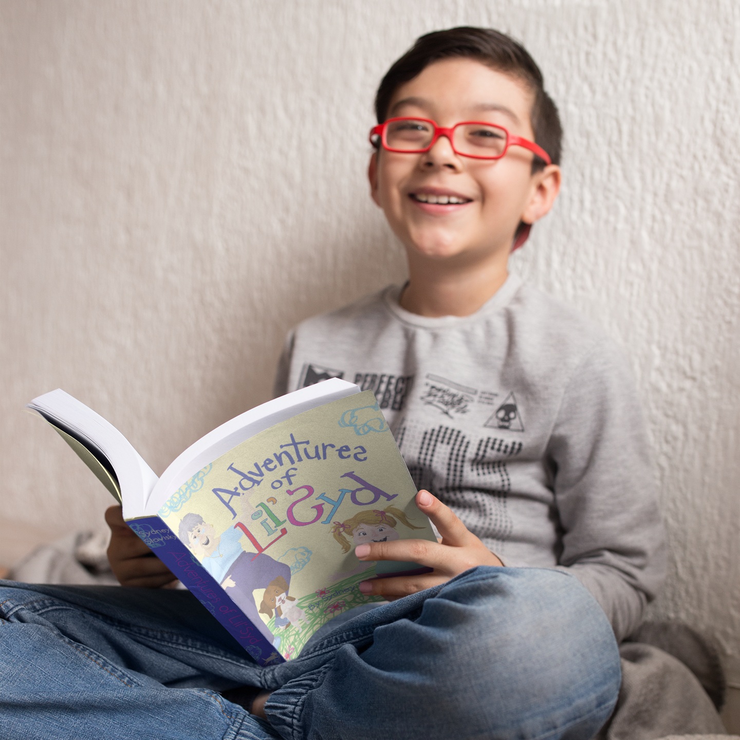 mockup-of-a-happy-boy-with-red-glasses-reading-a-book-in-his-room-a19149.jpg